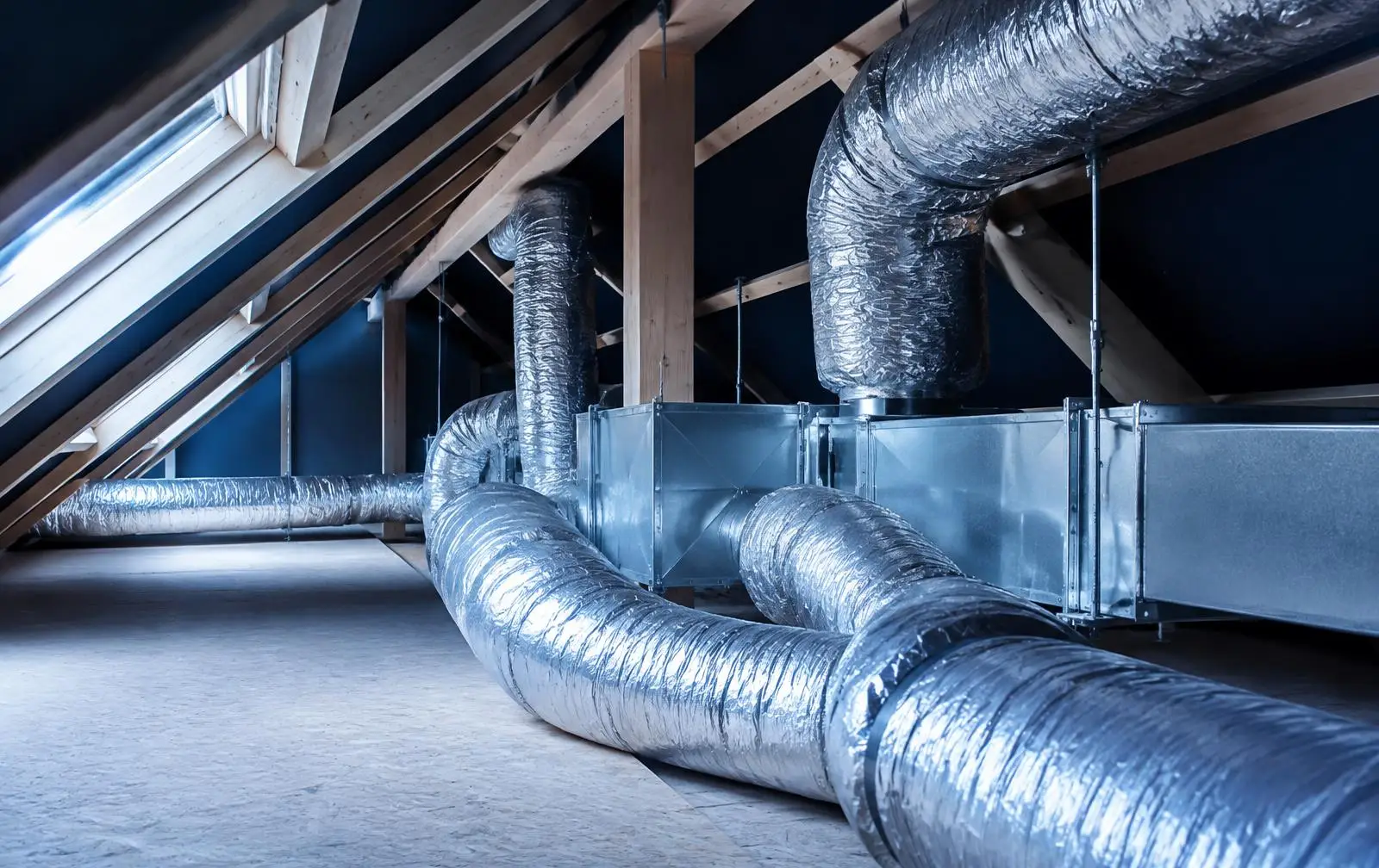 Insulated flexible and sheet-metal ductwork runs installed across an attic