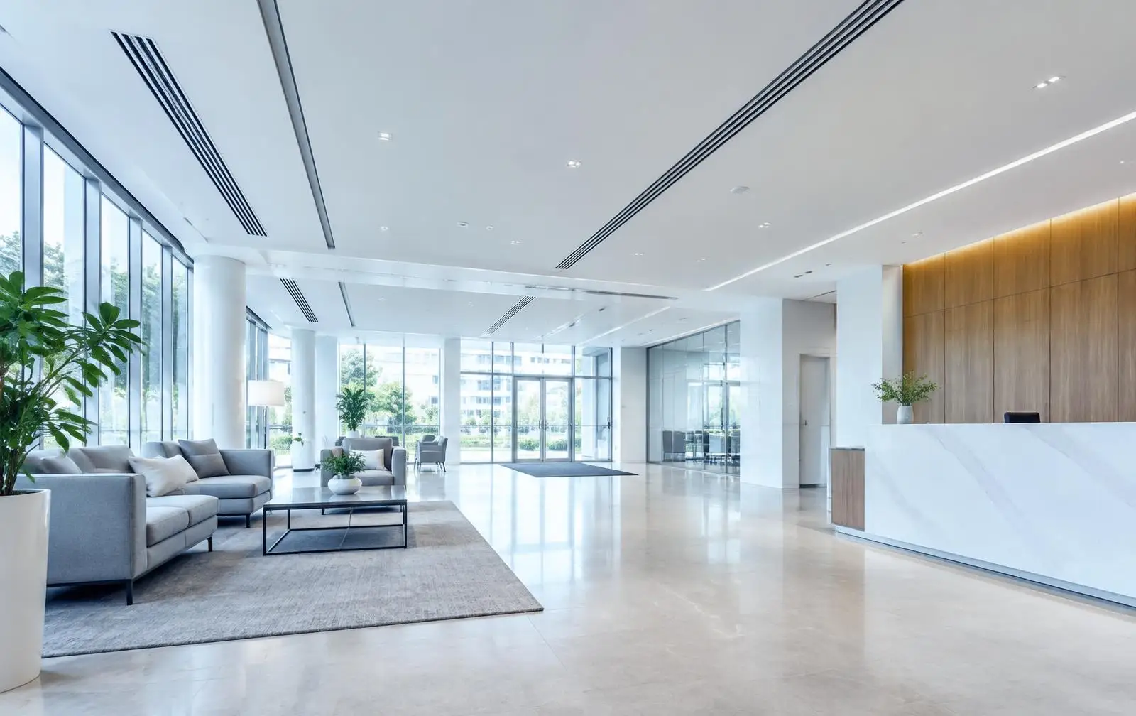 Bright commercial lobby with linear ceiling supply diffusers and return grilles